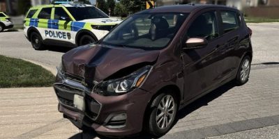 Barrie Police cruiser parked behind a crashed vehicle that struck a light pole after the driver allegedly fled officers twice.