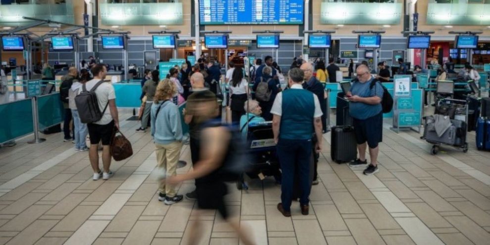 Travellers wait at the check-in area for cancelled WestJet flights at Vancouver International Airport