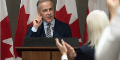 Prime Minister Mark Carney receives a standing ovation during an address to Liberal MPs in Ottawa on Sept. 18, 2026.