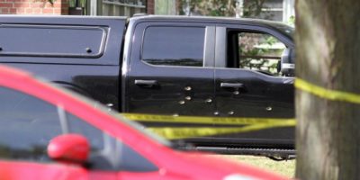 Bullet holes in a pickup truck near the scene of a shooting outside a Belleville synagogue