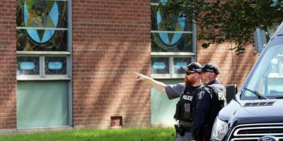 Police stand outside the Sons of Jacob synagogue in Belleville after a shooting