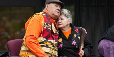 Elder Claudette Commanda embraces residential school survivor Eugene Arcand during a Survivor's Flag ceremony on Parliament Hill in Ottawa.