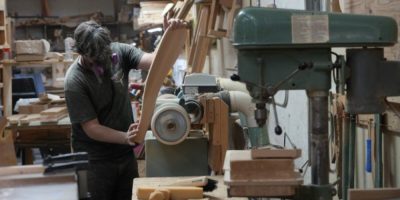 Worker sands an Adirondack chair at a furniture factory in Kemptville, Ontario
