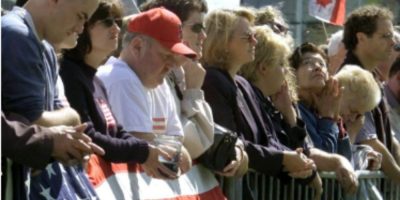 People bow their heads during three minutes of silence at a memorial ceremony in Ottawa on September 14, 2001, for victims of the 9/11 attacks.