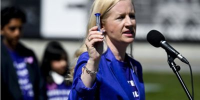 Children First Canada CEO Sara Austin speaks during a rally on Parliament Hill in Ottawa.