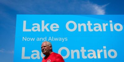 Ontario Premier Doug Ford unveils a sign for Lake Ontario at Fifty Point Conservation Area in Grimsby, Ontario, on Aug. 29, 2026.
