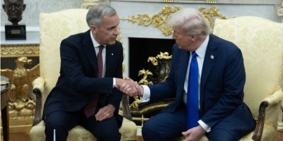 Prime Minister Mark Carney shakes hands with U.S. President Donald Trump in the Oval Office.