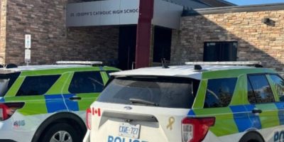 Two Barrie Police vehicles parked outside St. Joseph's Catholic High School.