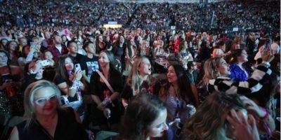 Fans watch Gracie Abrams perform as the opening act before Taylor Swift at the Eras Tour in Vancouver