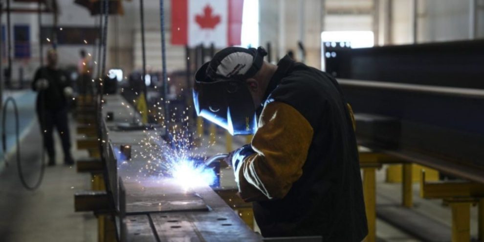 Welder works at Walters Group steel fabrication plant in Hamilton, Ontario