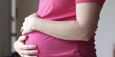 Pregnant woman standing for a portrait