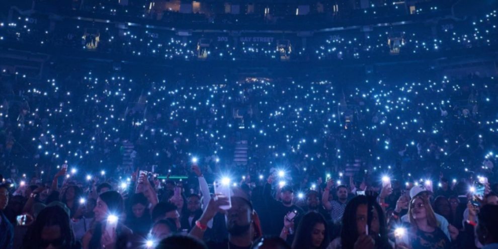 Fans wave their phone flashlights ahead of Vybz Kartel’s performance at Scotiabank Arena in Toronto on October 26, 2025.