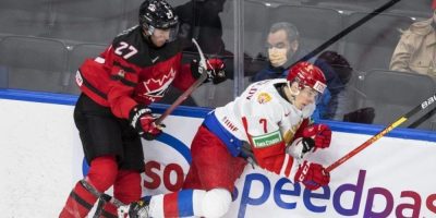 Canada's Will Cuylle checks Russia's Arseni Koromyslov during world junior hockey exhibition action in Edmonton on Dec. 23, 2021.