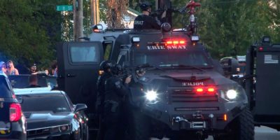 Police gather outside a home in Erie, Pennsylvania, on Oct. 9, 2026, where a shooting left eight victims and the suspected gunman dead.