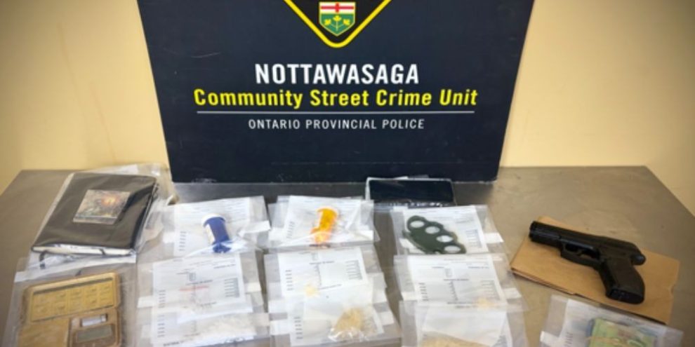 Items seized by OPP during a drug trafficking investigation in Essa Township, including suspected drugs, cash, brass knuckles and an imitation handgun.